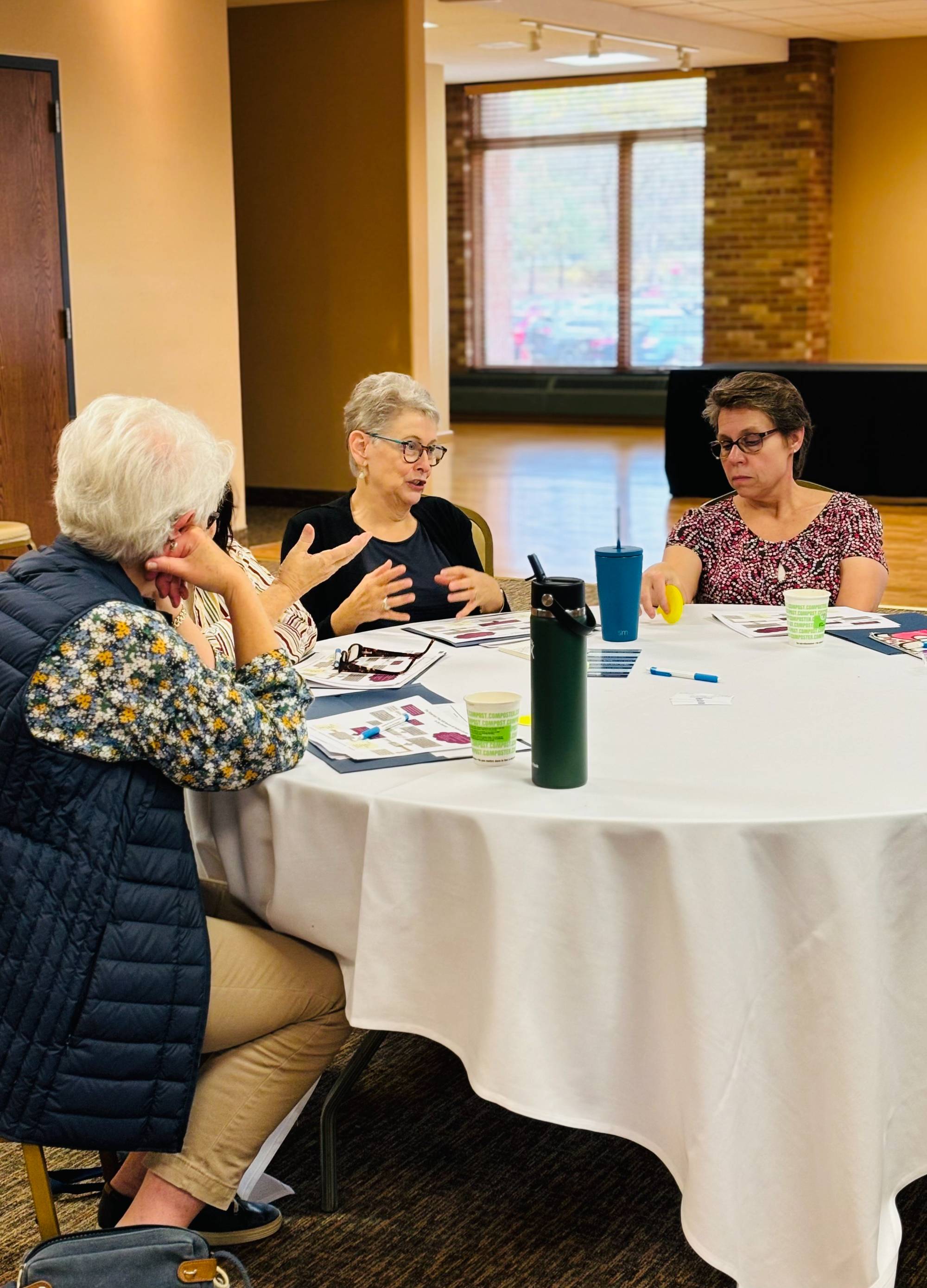 Aquinas College attendees talking to one another